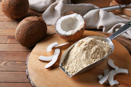 Scoop with coconut flour on wooden backgroundの写真素材