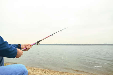 Man fishing on river bank