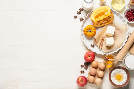 Ingredients for preparing pumpkin pie on white wooden backgroundの写真素材
