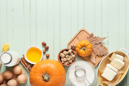 Ingredients for preparing pumpkin pie on color wooden backgroundの写真素材