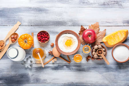 Ingredients for preparing pumpkin pie on wooden backgroundの写真素材