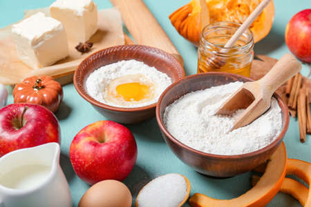Ingredients for preparing pumpkin pie on color background