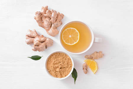 Composition with cup of ginger tea on light wooden backgroundの写真素材