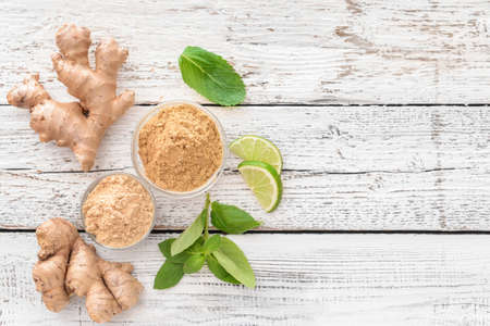 Composition with ginger powder on light wooden backgroundの写真素材
