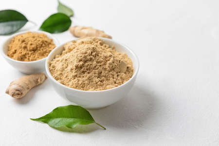 Composition with ginger powder on white backgroundの写真素材