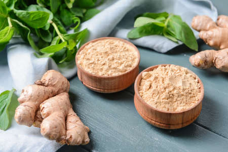 Composition with ginger powder on color wooden backgroundの写真素材