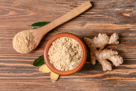 Composition with ginger powder on wooden backgroundの写真素材