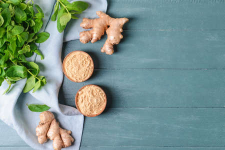 Composition with ginger powder on color wooden backgroundの写真素材