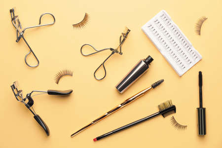 Composition with false eyelashes and tools on color backgroundの写真素材