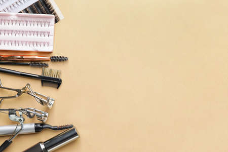 Composition with false eyelashes and tools on color backgroundの写真素材