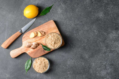 Composition with ginger powder on dark backgroundの写真素材