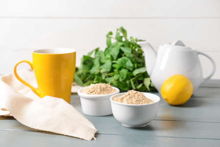 Composition with ginger powder on wooden backgroundの写真素材