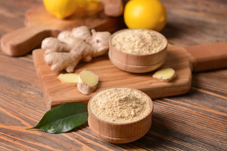 Composition with ginger powder on wooden backgroundの写真素材