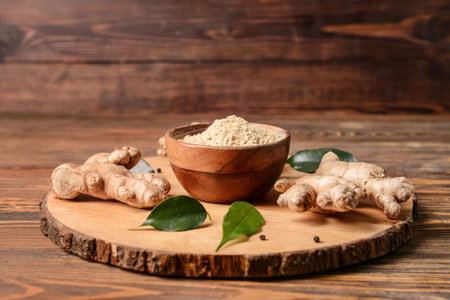 Composition with ginger powder on wooden backgroundの写真素材