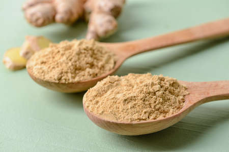 Spoons with ginger powder on color background, closeupの写真素材