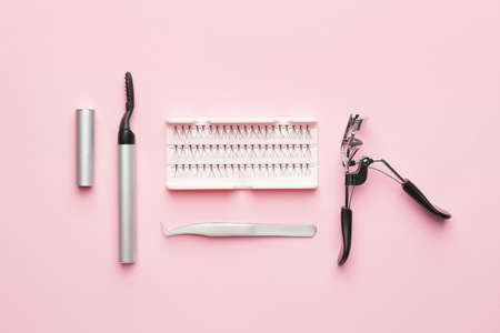 Composition with false eyelashes and tools on color backgroundの写真素材