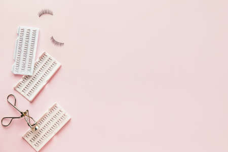 Set of false eyelashes and curler on color backgroundの写真素材