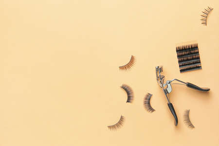 Set of false eyelashes and curler on color backgroundの写真素材