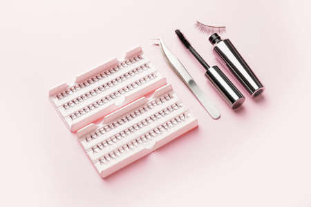Set of false eyelashes, black mascara and tweezers on color backgroundの写真素材
