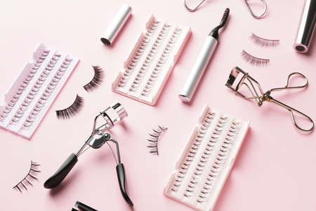Composition with false eyelashes and tools on color backgroundの写真素材