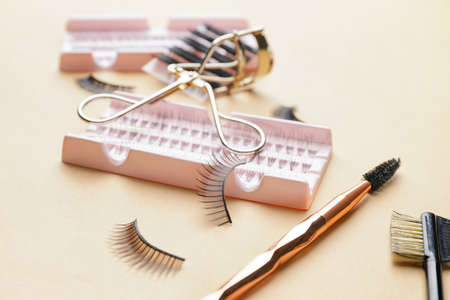 Composition with false eyelashes and tools on color background, closeupの写真素材