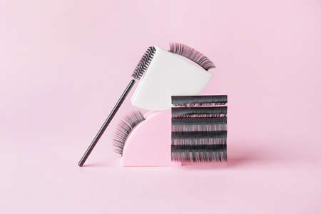 Composition with false eyelashes and brush on color backgroundの写真素材