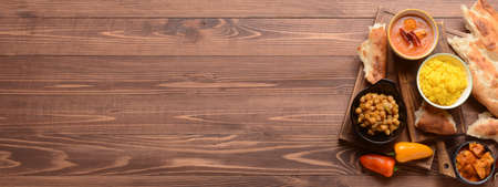 Traditional Indian food on wooden background with space for textの写真素材