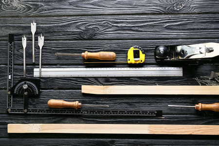 Set of carpenter's tools on dark wooden backgroundの写真素材