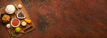 Traditional Indian food and spices on color background with space for textの写真素材