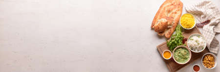 Traditional Indian food and spices on light background with space for textの写真素材