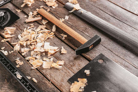 Set of carpenter's tools and saw dust on wooden backgroundの写真素材