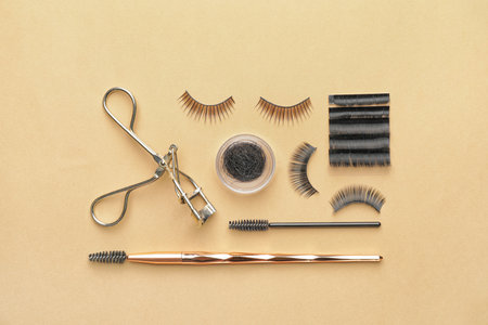 Composition with false eyelashes and tools on color backgroundの写真素材