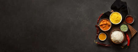 Traditional Indian food with spices on dark background with space for textの写真素材