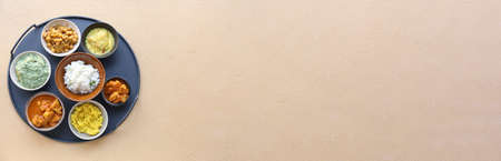 Tray with traditional Indian food on color background with space for textの写真素材