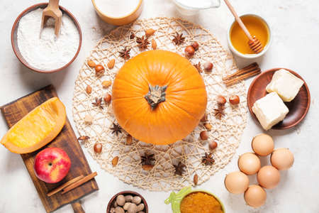 Ingredients for preparing pumpkin pie on light backgroundの写真素材