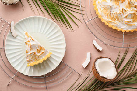Plate with piece of tasty coconut pie on color backgroundの写真素材
