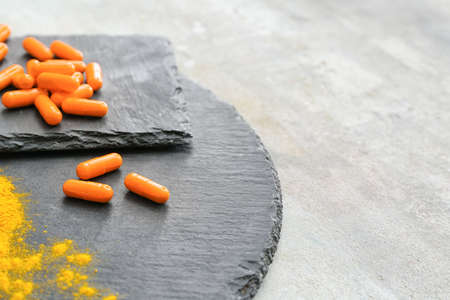 Turmeric pills and powder on grunge backgroundの写真素材