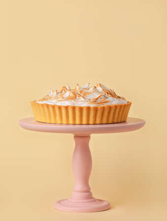 Dessert stand with tasty coconut pie on color backgroundの写真素材