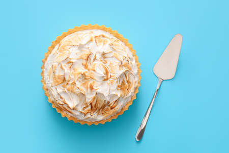 Tasty coconut pie and spatula on color backgroundの写真素材