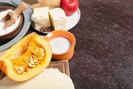 Ingredients for preparing pumpkin pie on dark backgroundの写真素材