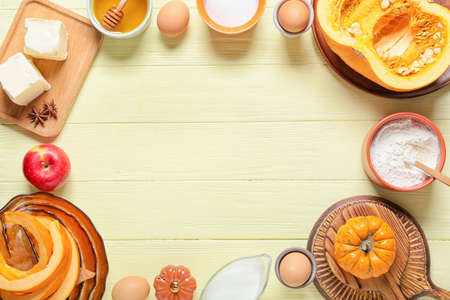 Frame made of ingredients for preparing pumpkin pie on color wooden backgroundの写真素材