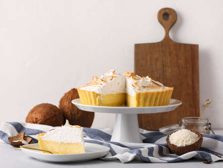 Plates with tasty coconut pie on light backgroundの写真素材