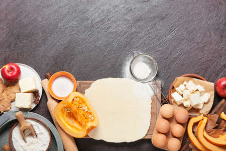Ingredients for preparing pumpkin pie on dark backgroundの写真素材