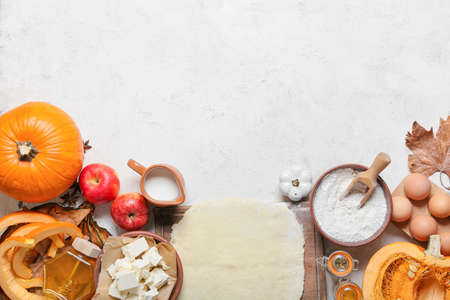Ingredients for preparing pumpkin pie on light backgroundの写真素材