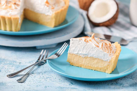 Plate with piece of tasty coconut pie on color backgroundの写真素材