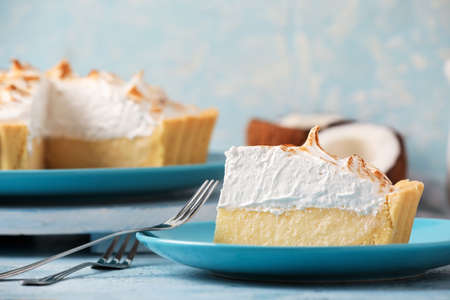 Plate with piece of tasty coconut pie on color backgroundの写真素材