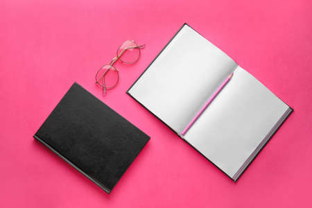 Books, pencil and eyeglasses on color backgroundの写真素材