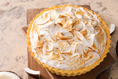 Board with tasty coconut pie on grunge backgroundの写真素材