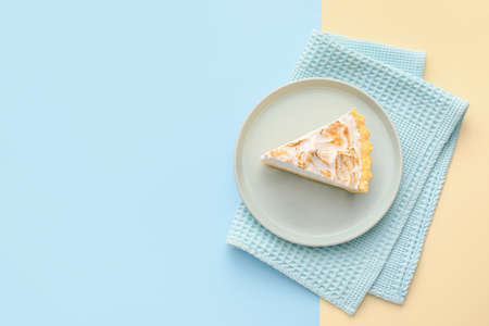 Plate with piece of tasty coconut pie on color backgroundの写真素材