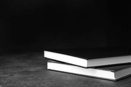 Stack of books on dark background, closeupの写真素材